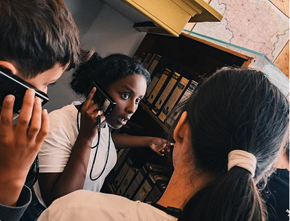 Students exploring Jewish heritage documents at the Jewish Museum Curaçao.