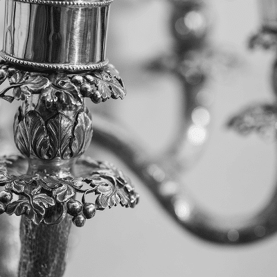 Close-up of ornate silver candle holder with floral detailing.